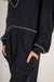 Black baggy jumpsuit with v-neck and flat seam details