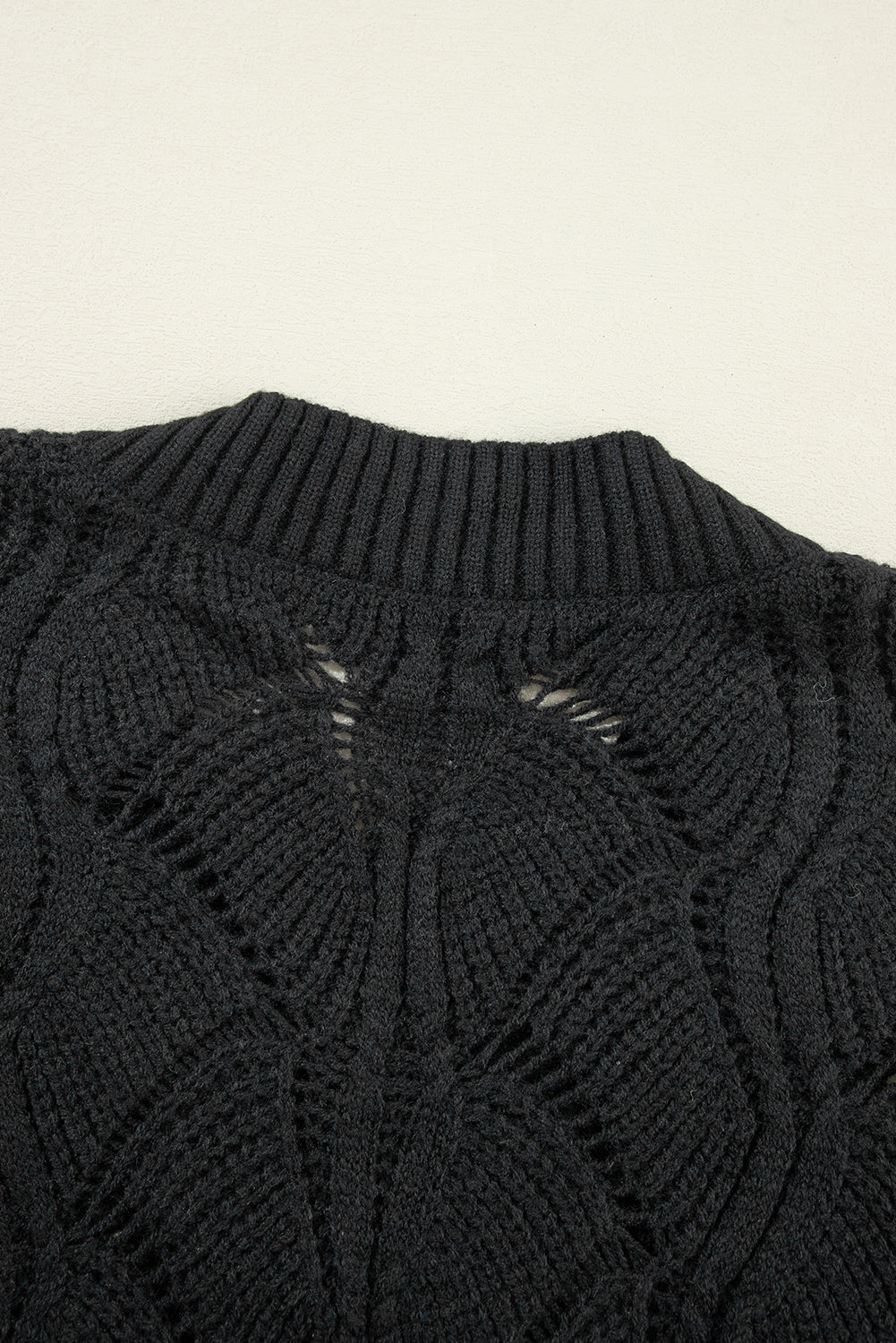 Black openwork knit sweater with V-neck and dropped shoulders