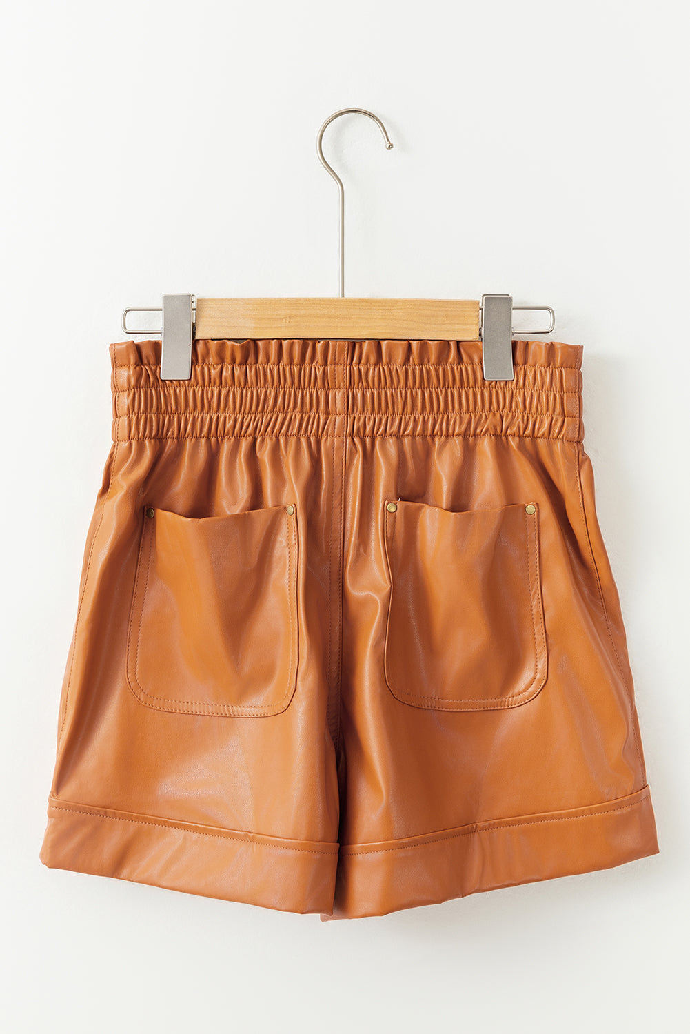 Brown faux leather high waisted shorts with patch pockets