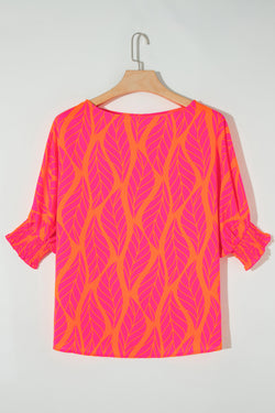 Smocked blouse with puffy sleeves and printed pink tropical leaves