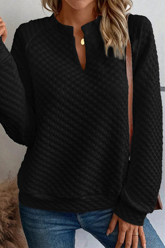 Black quilted top with long sleeves and split collar