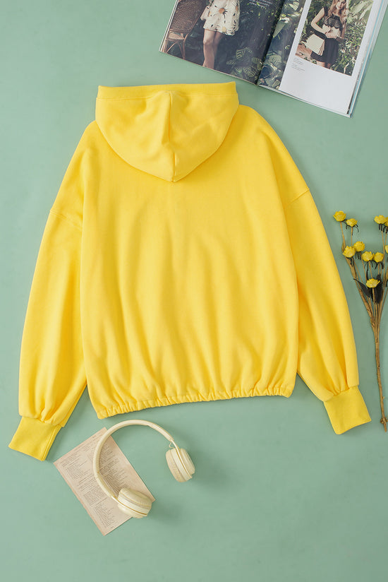 Sweat à capuche zippé jaune avec poche kangourou et bordure côtelée