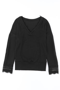 Black long sleeve v-neck top with lace trim and ribbed texture