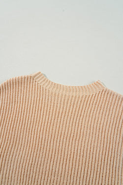 Ample knitted apricot knit sweater with drooping shoulders and side slits