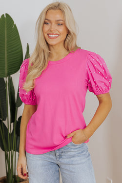 Bright ribbed pink with puffy sleeves and pearls *