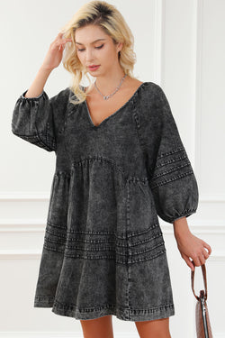 Black pleated denim babydoll dress with v-neck and puff sleeves