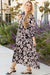 Long black dress with floral print and large puffing sleeves