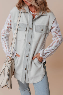 Light grey jacket with flap pockets and contrasting buttons on the front