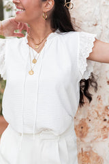 White textured blouse with embroidered ruffles *