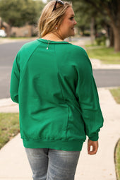 Bright green sweatshirt with exposed seams, notched collar and dropped shoulders