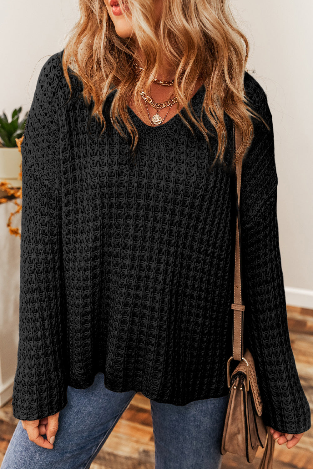 Black V-neck sweater with openwork crochet
