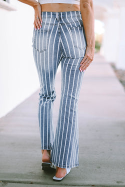 Flared jeans torn with vertical blue sky stripes