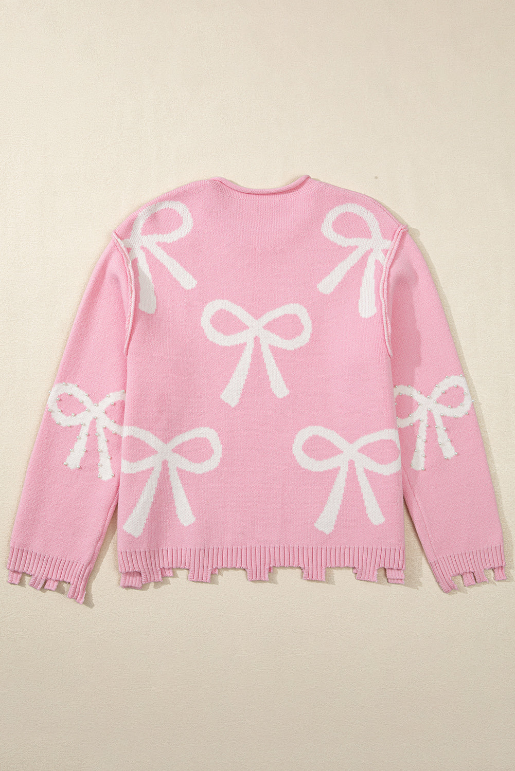 Pull à ourlet fendu en détresse à motif de nœud perlé rose