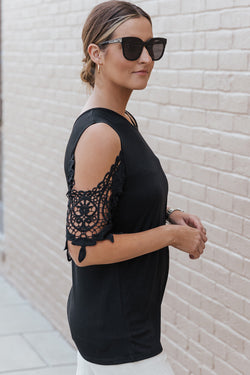 Black top with bare shoulders and lace straps