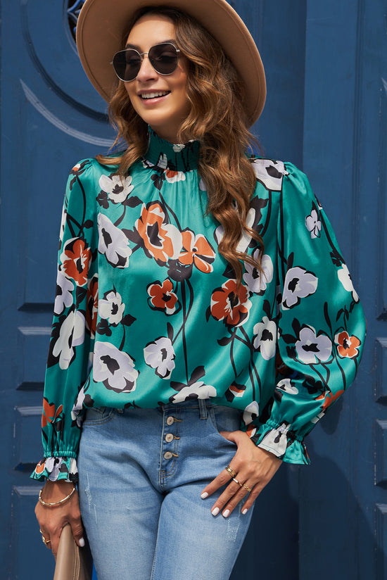 Blusa ahumada con un collar vertical y estampado floral