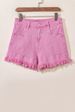 Mid-rise pink denim shorts with frayed edges