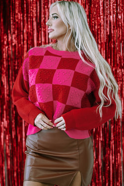 Textured sweater with multi-colored plaid pattern and heart detail