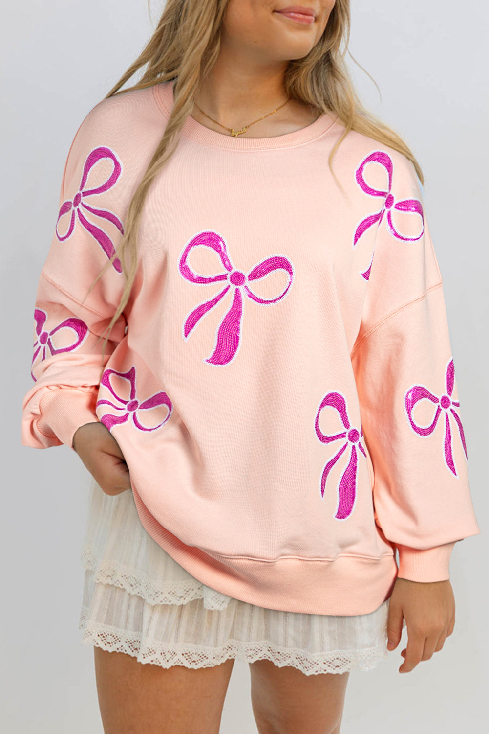 Sudadera de albaricoque rosa de gran tamaño con brillo y nudo de mariposa caída