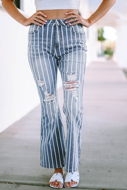 Flared jeans torn with vertical blue sky stripes