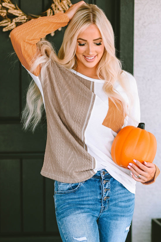 Orange textured knit top with long sleeves and color block chest pocket