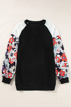 Black ribbed blouse with long sleeves and floral patchwork