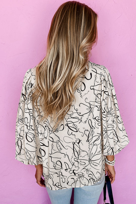 Beige blouse with round neck and abstract print balloon sleeves