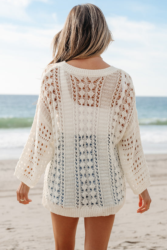 Pull blanc en tricot ajouré à manches bouffantes*