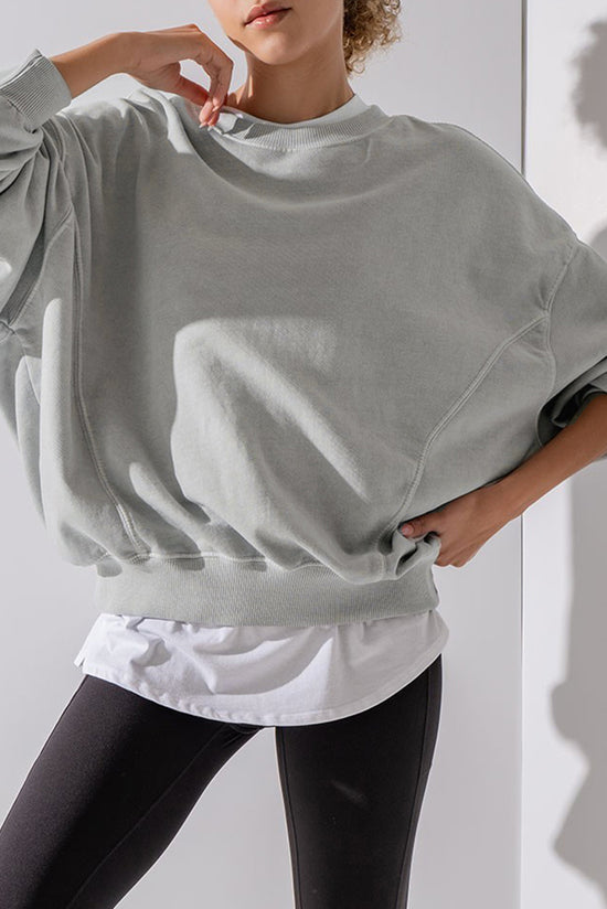 Grey sweatshirt with exposed seams, batwing sleeves and dropped shoulders