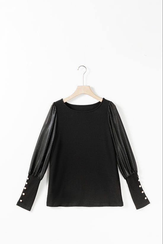 Black top with puffed sleeves and buttoned cuffs