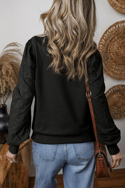 Plain black sweatshirt with patchwork sleeves and round neck