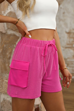 Large shorts with bright pink cargo pocket