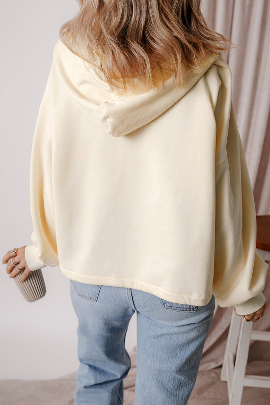 Beige loose hoodie with kangaroo pockets and semi-ferms flash lined with fleece