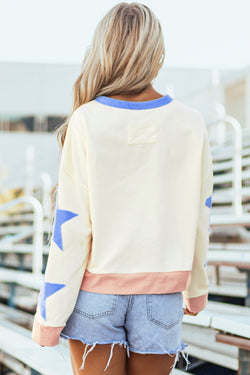 Beige oversized sweatshirt with patchwork stars and visible stitching