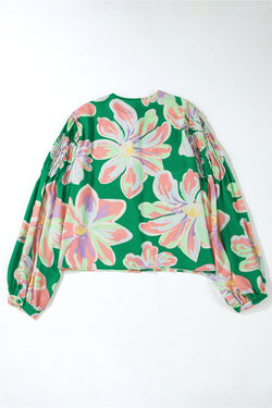 Large folded shirt with puffy sleeves and green floral print button