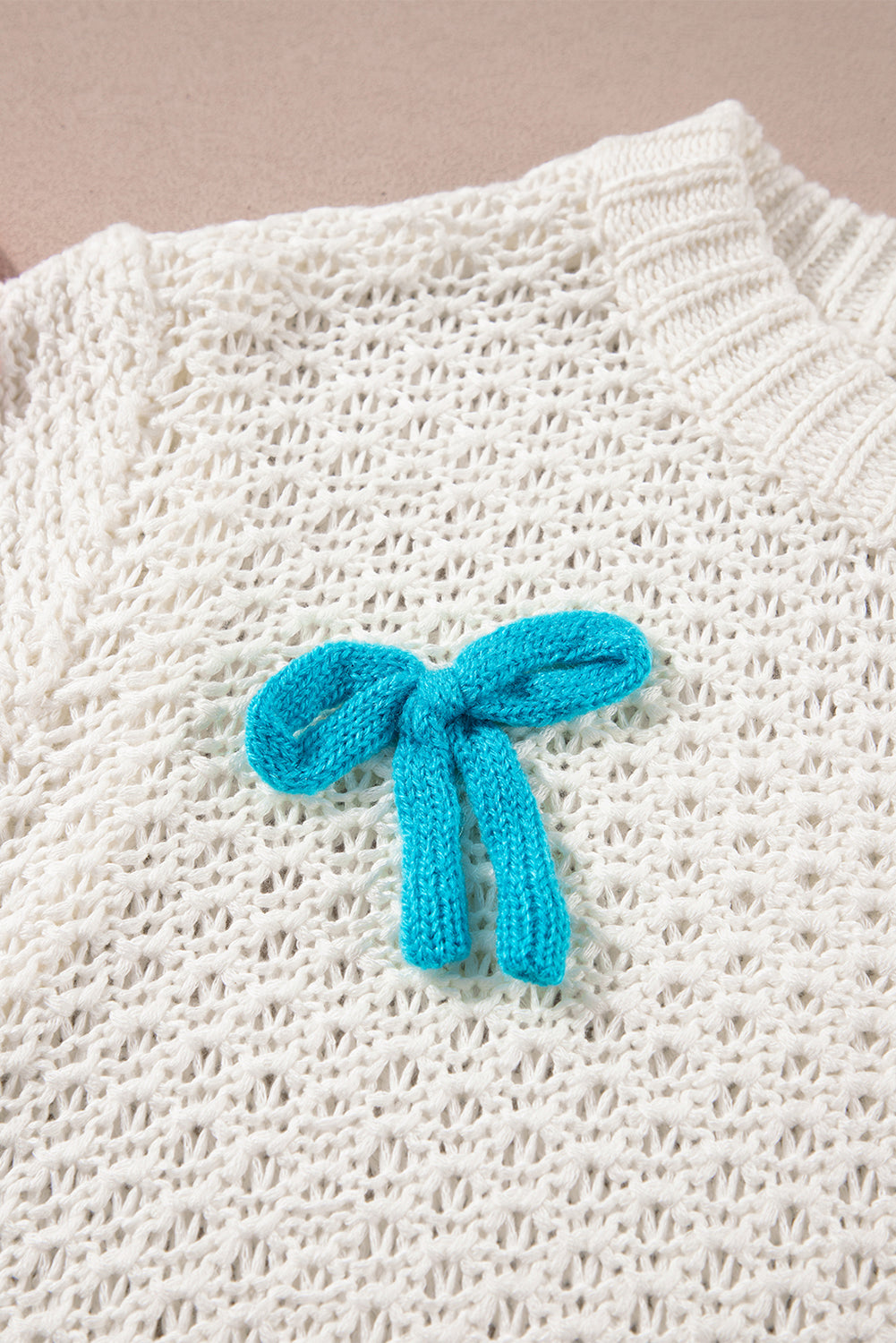 Pull blanc à manches courtes et col montant en tricot avec nœud coloré
