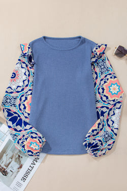 Ashleigh - Blue blouse with ruffles and floral sleeves in woven knitting with round neck