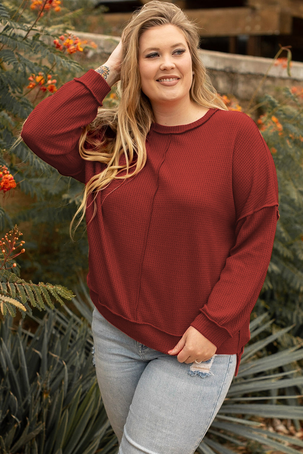 Plus size waffle knit top with exposed seams and gold flame