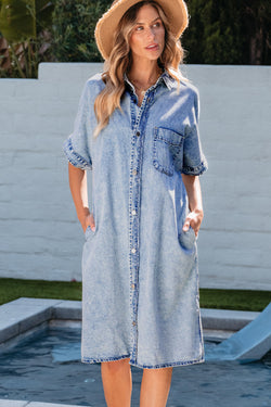 Light blue chambray shirt dress with short sleeves and medium washing