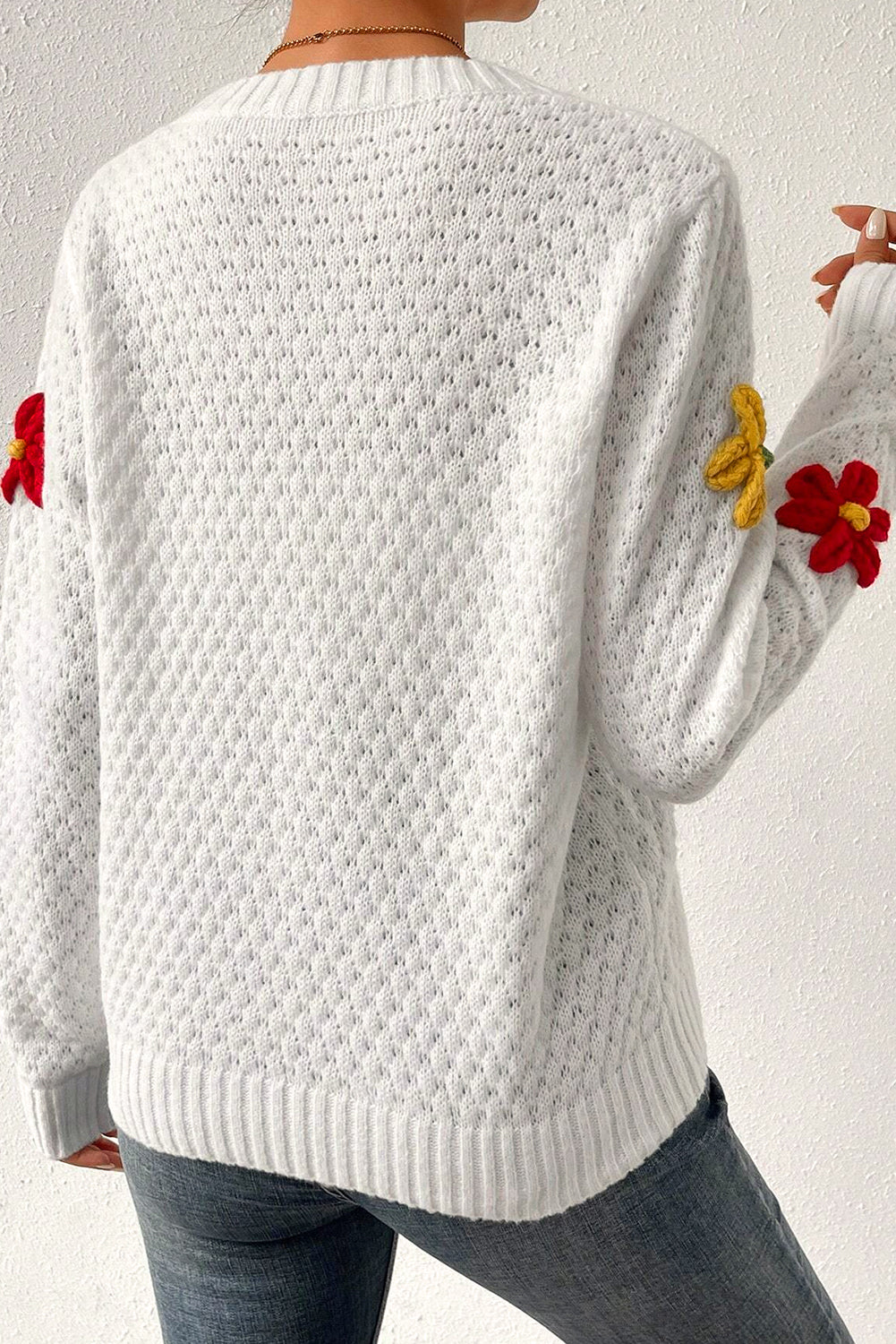 Textured knit sweater with white colorful flower appliques