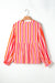 Orange striped blouse, balloon sleeves, notched v collar, buttoned on the front