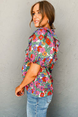 Red blouse with puffy sleeves and ruffles with split collar and floral tie