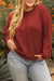 Plus size waffle knit top with exposed seams and gold flame