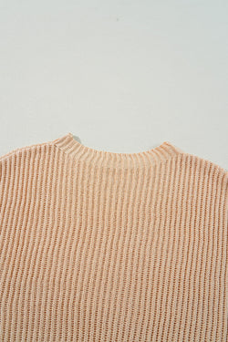 Ample knitted apricot knit sweater with drooping shoulders and side slits