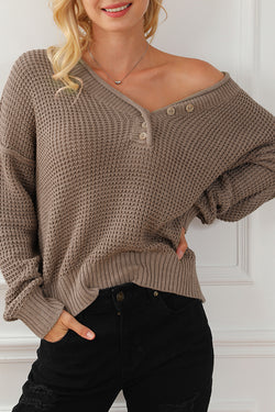 Khaki tricot sweater buttoned with V -neck button and drooping shoulders