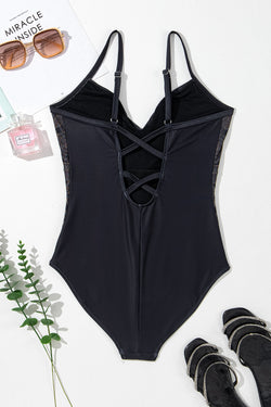 Black swimsuit with thin suspenders and crossed petals on the back