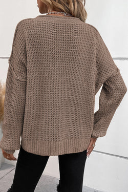 Khaki tricot sweater buttoned with V -neck button and drooping shoulders