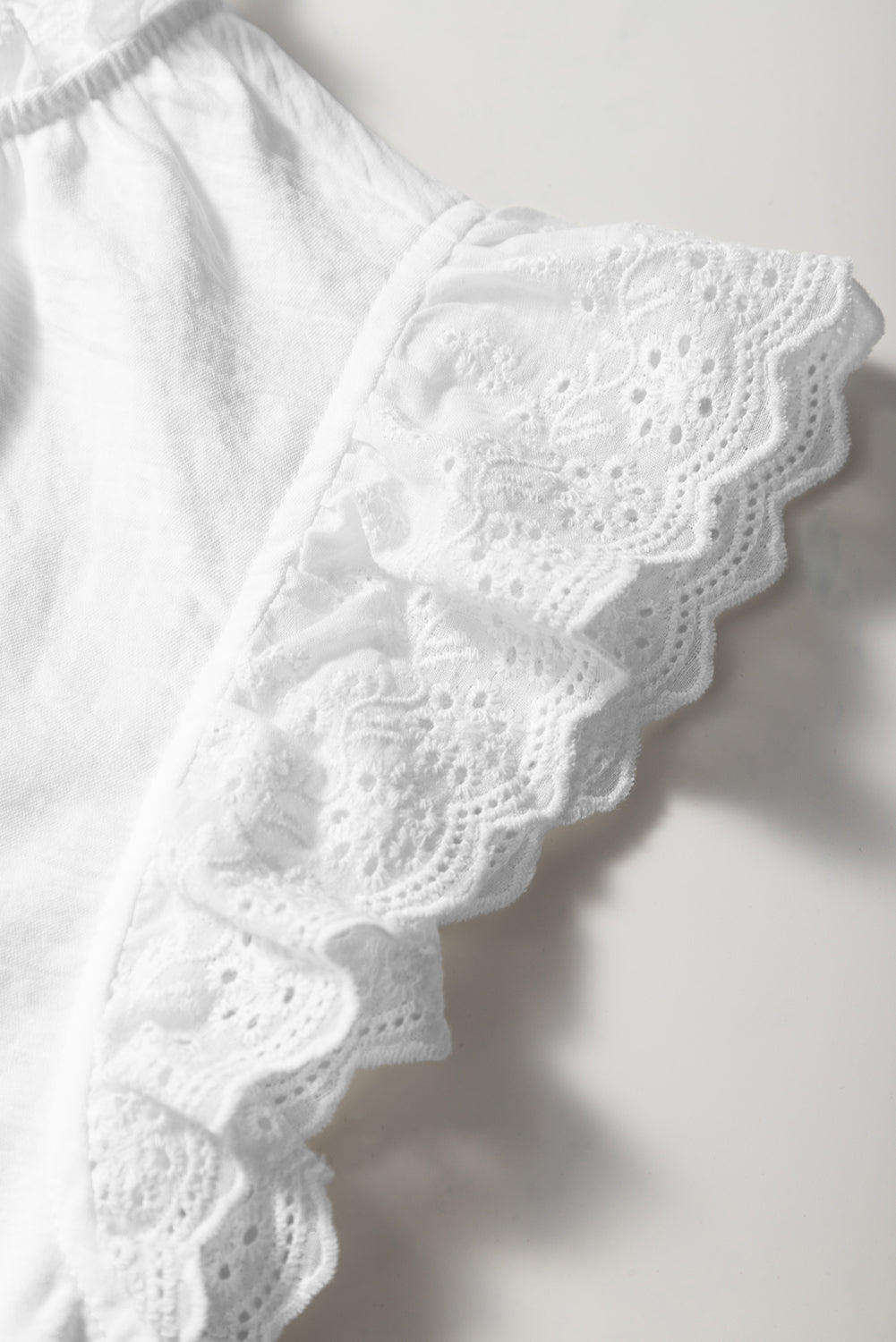 White textured blouse with embroidered ruffles *