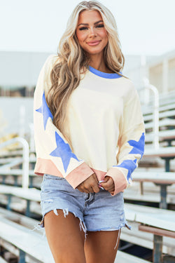 Beige oversized sweatshirt with patchwork stars and visible stitching