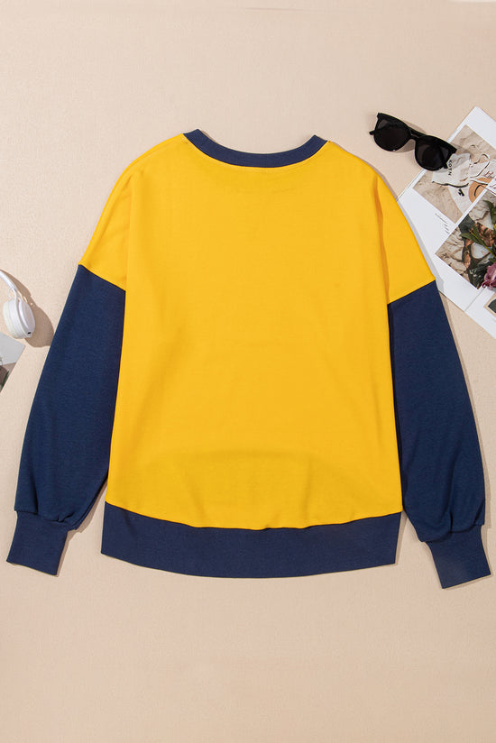 Yellow sweatshirt with dropped shoulders and sleeves with thumb hole