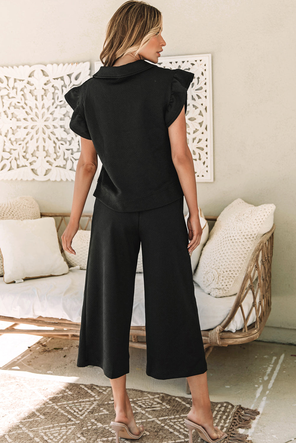 Black textured top and wide leg pants set with flutter sleeves